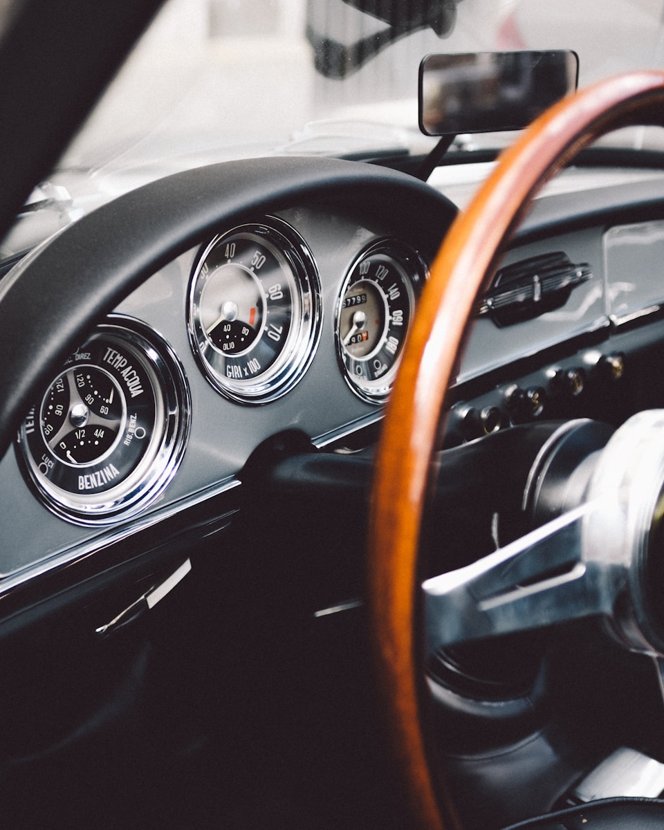 focus photography of vehicle steering wheel, antique car