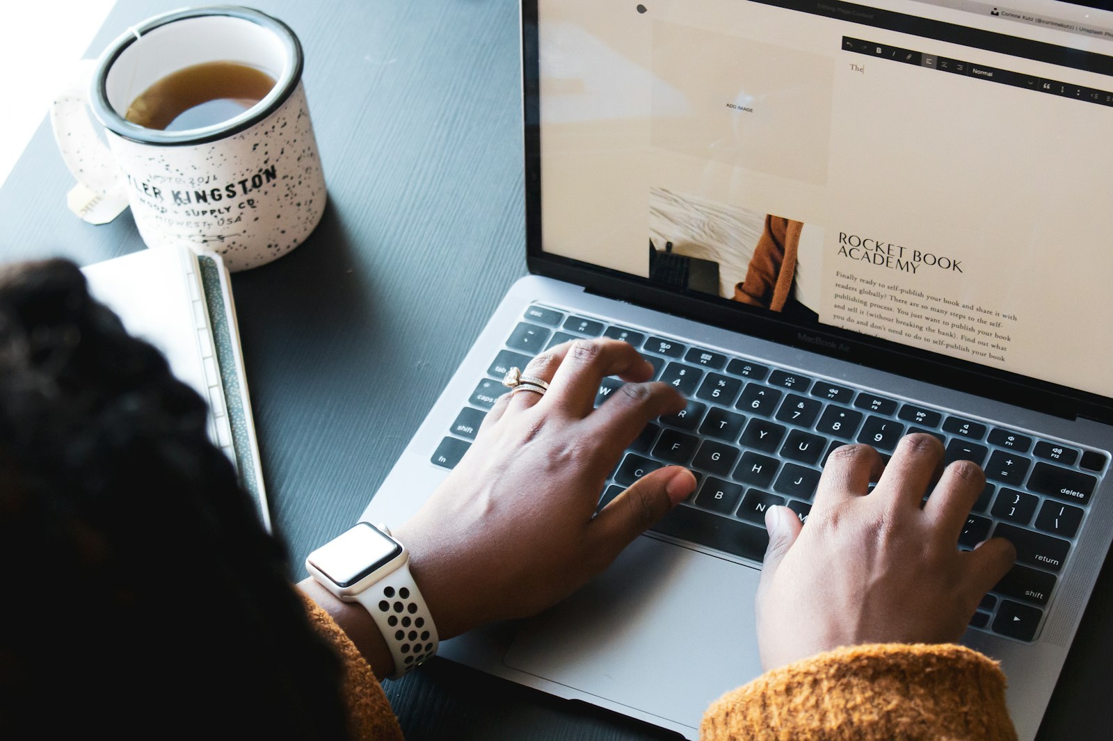 person using macbook pro on black table, freelance
